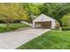 Exterior view featuring a detached garage with ample parking space and a well-manicured lawn at 2234 Hamilton Mill Rd, Charlotte, NC 28270
