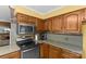Close-up of the kitchen showing stainless steel appliances, stone countertops and wood cabinets at 2234 Hamilton Mill Rd, Charlotte, NC 28270
