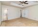 Bedroom with ceiling fan and a view of the ensuite bathroom with tiled shower at 226 Scenic View Ln, Matthews, NC 28104