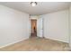 Cozy bedroom featuring neutral carpet, white walls, and access to the bathroom at 226 Scenic View Ln, Matthews, NC 28104