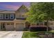 Charming townhome with a one-car garage, well-maintained lawn, and mature landscaping at 226 Scenic View Ln, Matthews, NC 28104