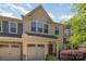 Inviting townhome showcasing a one-car garage, neat lawn, and lush, mature landscaping at 226 Scenic View Ln, Matthews, NC 28104