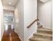 Hallway featuring hardwood floors, access to staircase, and connection to other rooms in the house at 226 Scenic View Ln, Matthews, NC 28104