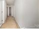 Clean hallway with neutral carpet and freshly painted white walls at 226 Scenic View Ln, Matthews, NC 28104