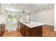 Open kitchen with granite countertops, stainless steel appliances and a view of the living room at 226 Scenic View Ln, Matthews, NC 28104