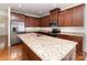 Close-up shot of a kitchen with dark wood cabinets, granite countertops, and stainless steel appliances at 226 Scenic View Ln, Matthews, NC 28104