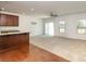 Open living space featuring an eat-in kitchen with dark wood cabinets and a spacious carpeted living room at 226 Scenic View Ln, Matthews, NC 28104