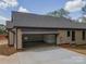 Attached two-car garage featuring modern architecture, offering ample space for vehicles and storage solutions at 2596 Polo Ln, Maiden, NC 28650