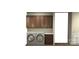 Laundry room with sleek cabinetry, modern washer/dryer setup, and convenient sink area at 2596 Polo Ln, Maiden, NC 28650