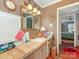 Charming bathroom featuring a decorative mirror, ample counter space, and warm lighting at 2620 Park Rd, Charlotte, NC 28209