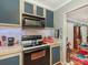 Efficient kitchen features oven, microwave, tile backsplash, and ample storage for convenient meal preparation and organization at 2620 Park Rd, Charlotte, NC 28209