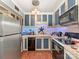 Functional kitchen with stainless steel refrigerator, microwave, classic cabinetry, and modern appliances at 2620 Park Rd, Charlotte, NC 28209