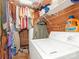 Functional laundry room with washer, shelving, and storage space for organization at 2620 Park Rd, Charlotte, NC 28209
