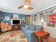 Inviting living room featuring a comfortable blue sofa, fireplace, and custom shelving creating a warm and welcoming space at 2620 Park Rd, Charlotte, NC 28209