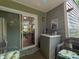 Enclosed porch with cabinet space, sliding glass doors, and comfortable seating at 2620 Park Rd, Charlotte, NC 28209