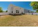 A spacious backyard with grass and a white fence, with patio and furniture at 269 Keating Place Dr, Fort Mill, SC 29708