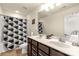 Bathroom featuring double sinks, spacious vanity, and a shower tub with a black and white curtain at 269 Keating Place Dr, Fort Mill, SC 29708
