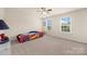 Comfortable bedroom with two windows, a ceiling fan, and neutral carpet at 269 Keating Place Dr, Fort Mill, SC 29708