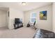 Well-lit bonus room with comfortable seating, exercise equipment and neutral carpeting at 269 Keating Place Dr, Fort Mill, SC 29708