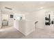 Upstairs hallway with neutral walls and carpeting, and access to the laundry and bedrooms at 269 Keating Place Dr, Fort Mill, SC 29708