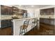 Open-concept kitchen with a granite countertop bar, stainless steel appliances, and ample cabinet space at 269 Keating Place Dr, Fort Mill, SC 29708