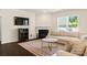 Inviting living room with fireplace, TV, plush seating, and hardwood floors at 269 Keating Place Dr, Fort Mill, SC 29708