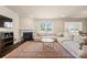 Comfortable living area with fireplace, hardwood floors, large windows, and an open floor plan at 269 Keating Place Dr, Fort Mill, SC 29708
