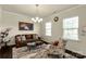 Comfortable living room featuring neutral walls, a chandelier, and plenty of natural light at 269 Keating Place Dr, Fort Mill, SC 29708