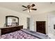 Main bedroom featuring neutral walls, ceiling fan, and dark wood furniture with ample storage at 269 Keating Place Dr, Fort Mill, SC 29708