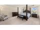 Main bedroom showcases a carpeted floor, a four-poster bed and a tufted accent chair at 269 Keating Place Dr, Fort Mill, SC 29708