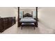 This main bedroom features a four poster bed and a dark wood dresser on carpeted floors at 269 Keating Place Dr, Fort Mill, SC 29708