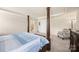 Bright main bedroom features carpeted floors, a 4-poster bed and an elegant accent chair at 269 Keating Place Dr, Fort Mill, SC 29708