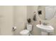 Well-lit powder room features a pedestal sink, toilet, and stylish decorative elements at 269 Keating Place Dr, Fort Mill, SC 29708