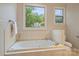 Relaxing bathroom featuring a large soaking tub with jets and a large window view of nature at 272 Harbor Ridge Dr, Statesville, NC 28677
