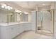 Bright bathroom featuring a dual sink vanity with white cabinets and a glass-enclosed shower at 272 Harbor Ridge Dr, Statesville, NC 28677