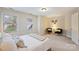 Cozy bedroom with neutral tones, two windows, and comfortable seating area at 272 Harbor Ridge Dr, Statesville, NC 28677
