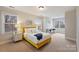 Bright bedroom with a yellow bed frame and a sitting area by the window at 272 Harbor Ridge Dr, Statesville, NC 28677