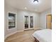 Cozy bedroom with a window and glass doors leading to a porch overlooking the serene lake at 272 Harbor Ridge Dr, Statesville, NC 28677