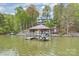 Home with a boat dock on the lake with a covered area for lake vehicles at 272 Harbor Ridge Dr, Statesville, NC 28677