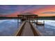 Covered dock at sunset, featuring inviting lighting, seating, and a charming waterfront setting at 272 Harbor Ridge Dr, Statesville, NC 28677