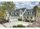 Beautiful home with a three-car garage, manicured landscaping, and a charming covered front porch at 272 Harbor Ridge Dr, Statesville, NC 28677