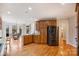 Open kitchen with stainless steel appliances, hardwood floors, and a view into the bay window dining room at 272 Harbor Ridge Dr, Statesville, NC 28677