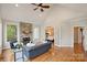 Living room featuring a stone fireplace, hardwood floors, and access to the Primary bedroom at 272 Harbor Ridge Dr, Statesville, NC 28677
