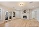 Spacious living room featuring a fireplace, light wood floors and access to a screened porch at 272 Harbor Ridge Dr, Statesville, NC 28677