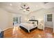 Main bedroom with hardwood floors and an ensuite living area overlooking a lake at 272 Harbor Ridge Dr, Statesville, NC 28677