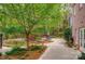 Lush backyard featuring a pond, waterfall, brick patio and mature landscaping at 305 Caledonia Way, Waxhaw, NC 28173