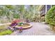 Stunning backyard oasis with multi tiered brick patio, pond, mature trees and manicured landscaping at 305 Caledonia Way, Waxhaw, NC 28173