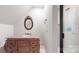 Cozy bathroom with elegant vanity, decorative mirror, and a tiled shower at 305 Caledonia Way, Waxhaw, NC 28173