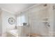 Bright bathroom with tiled shower, soaking tub, and stylish fixtures at 305 Caledonia Way, Waxhaw, NC 28173