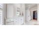 Bright bathroom featuring white cabinets, drawers, and a mirror complemented by tile flooring at 305 Caledonia Way, Waxhaw, NC 28173